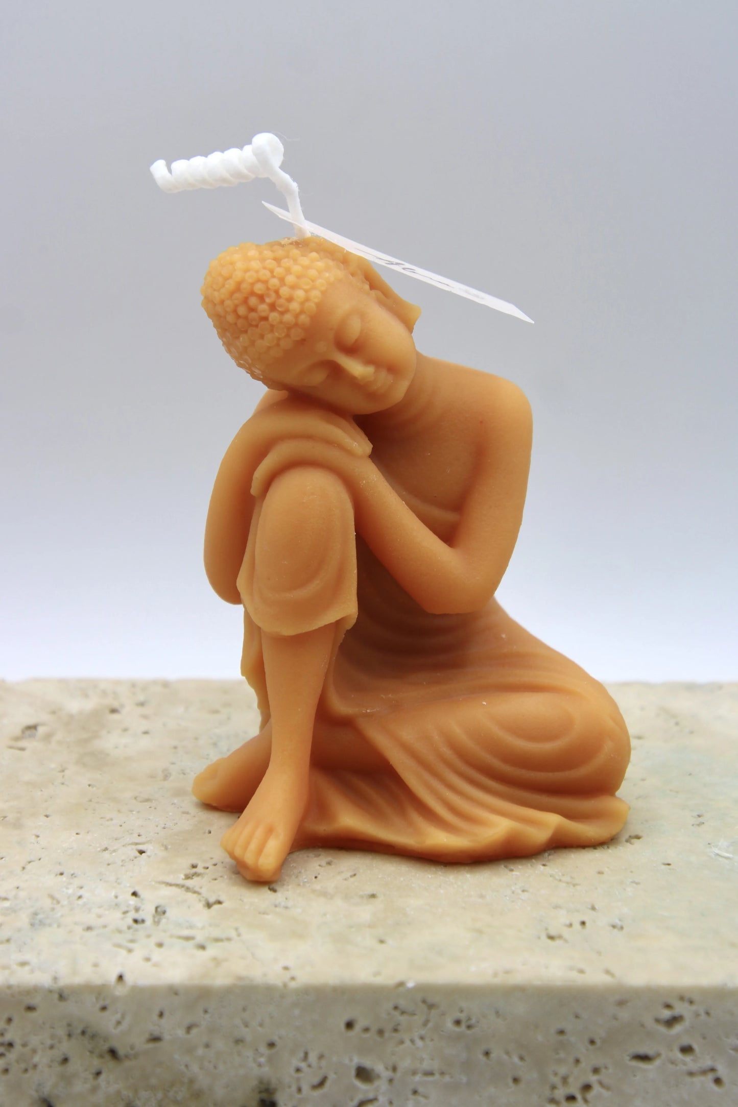Alma Gift Dreamer Buddha handmade orange candle sculpture on marble base, Miami Beach