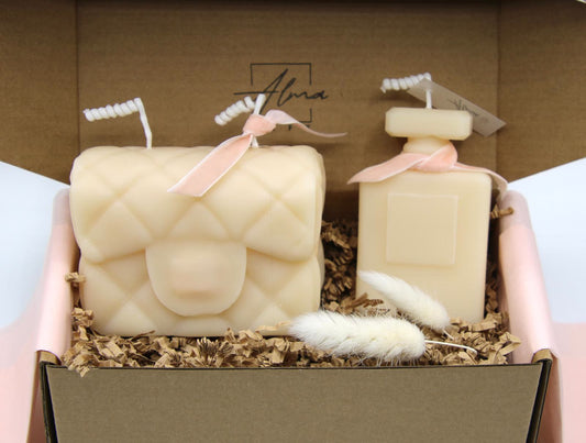 Quilted purse candle and perfume bottle candle in ivory with pink velvet bows, in a kraft gift box with crinkle paper and dried bunny tails