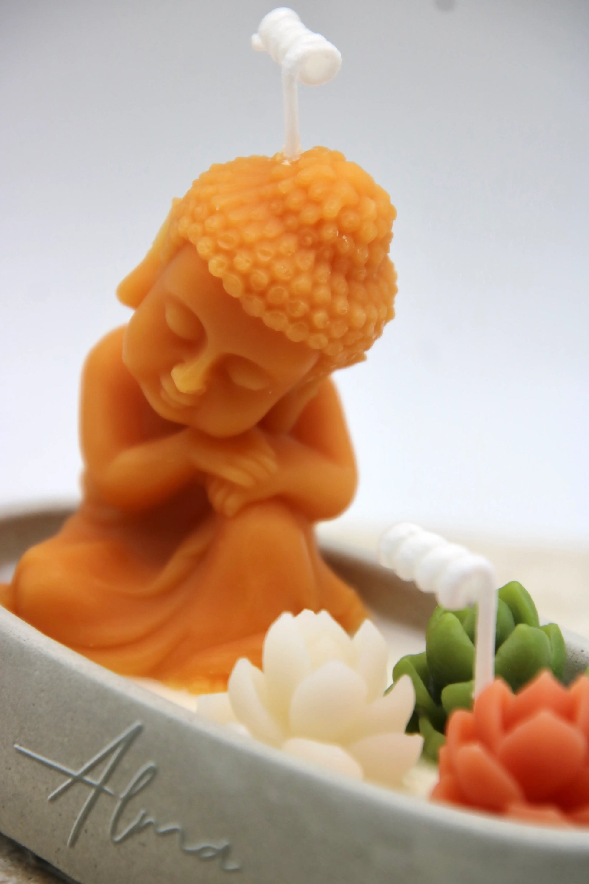 zen decorative candle with buddha figure and floral details handmade spiritual home decor