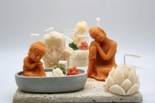 Orange Buddha candles with a lotus flower candle